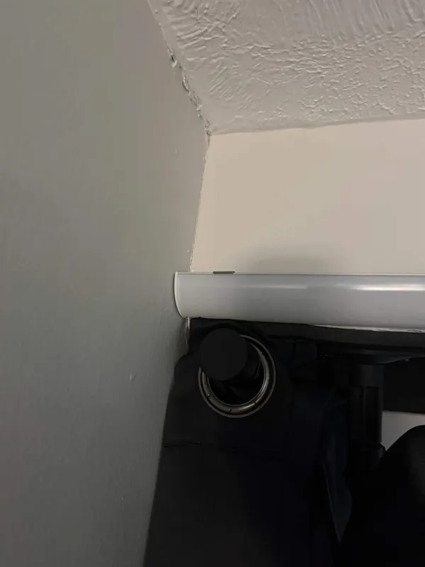 An LED diffuser channel fitted into the corner where the impact screen meets the ceiling.